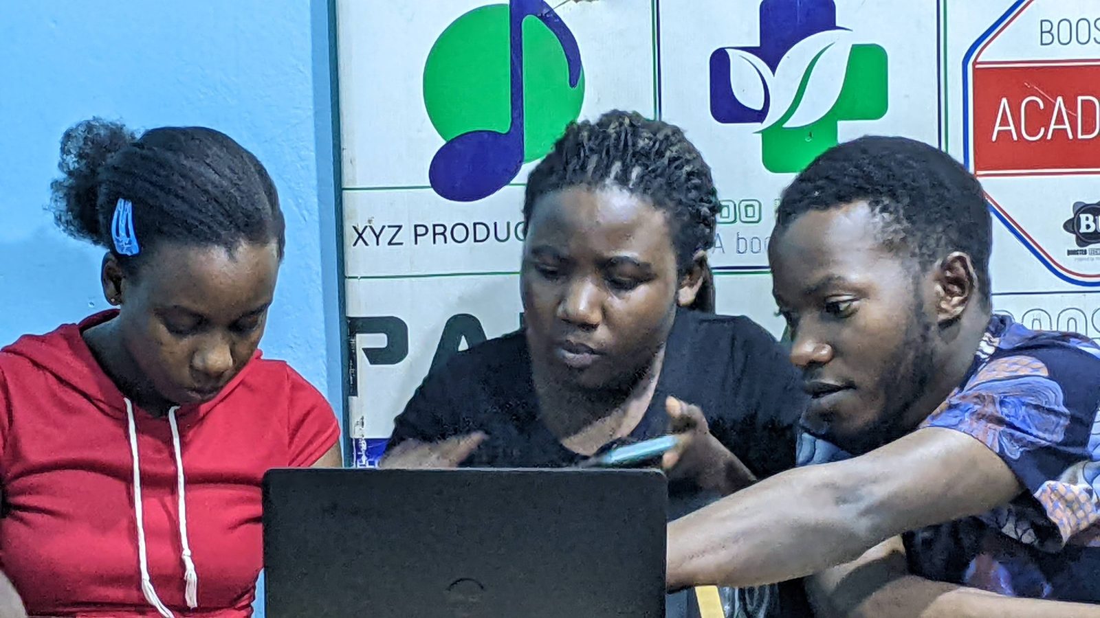 Youth working on laptops during a training session